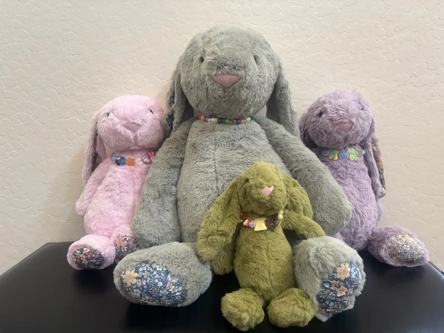 Plush bunnies with custom beaded collars made in the craft room