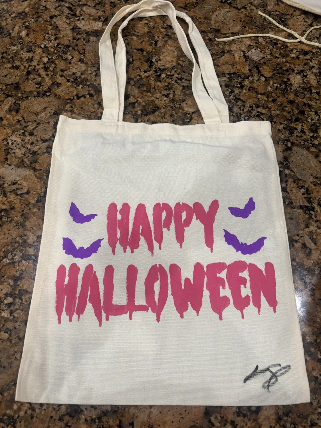 A hand-painted canvas tote bag