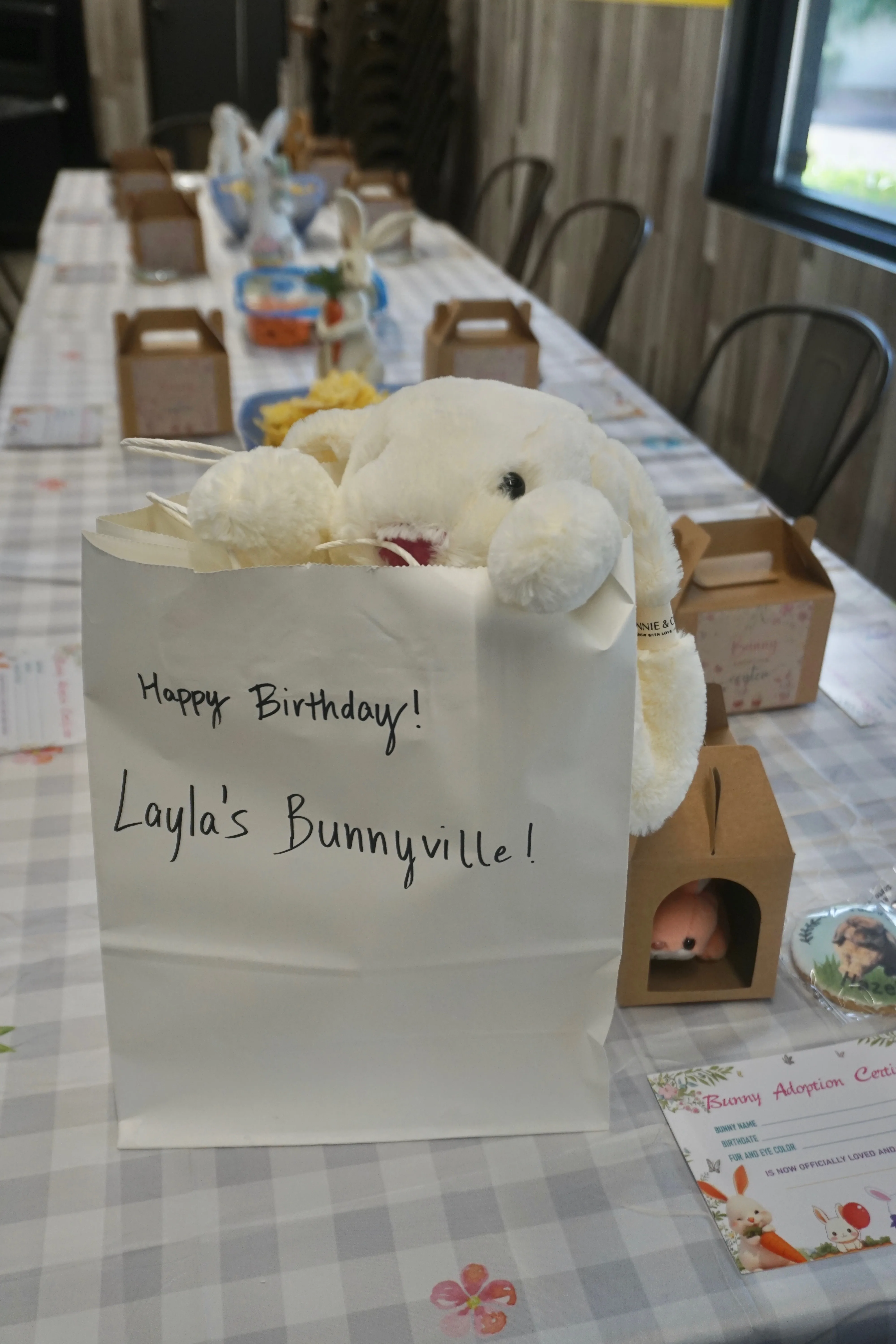 A Happy Birthday Layla's Bunnyville gift bag with a stuffed bunny